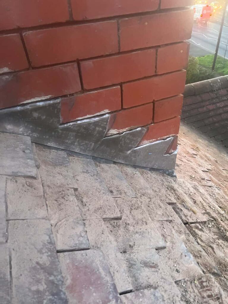 This is a photo of new leadwork being installed around an old chimney. Works carried out by Brownsover Roofing Repairs